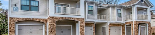 the exterior of a house with two garages