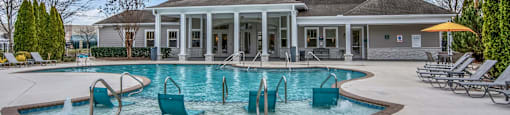 the swimming pool at the clubhouse at the estates apartments