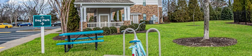 a bicycle parked at a playground in front of a house