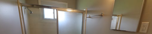 A bathroom with a toilet, sink, and shower.