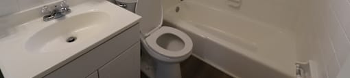 A white sink and toilet in a bathroom.