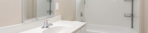a bathroom with a sink and a shower and a toilet