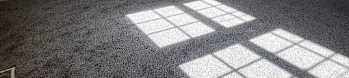 A white wall with a vent and a window casting a shadow on the wall.