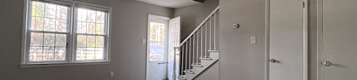 A staircase with a window on the landing.