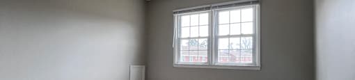 A small room with a window and a door.