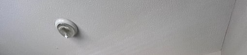 A wall-mounted air conditioner unit is installed in a room.