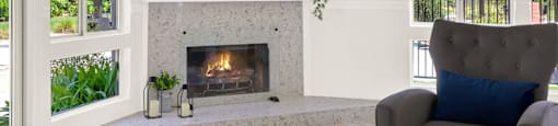a living room with a fireplace and a chair at Monterra Ridge Apartments, California,91351