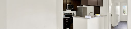 an open kitchen and living room with a ceiling fan at Monterra Ridge Apartments, California,91351
