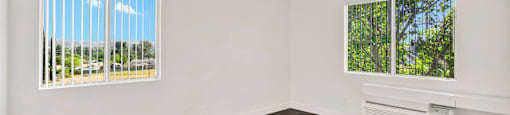 an empty living room with wood flooring and a window at Monterra Ridge Apartments, California,91351