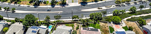 an aerial view of a parking lot with houses and trees at Monterra Ridge Apartments, California,91351