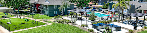 a park with a playground and a pool in a community at Monterra Ridge Apartments, Canyon Country, California