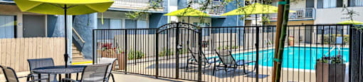 our apartments have a pool and a patio with tables and chairs at Sunset Square Apartments, West Covina, California, 91790