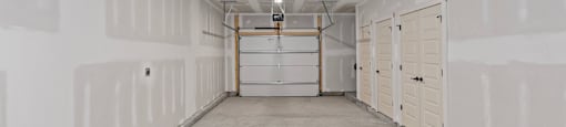 the inside of a garage with white walls and white doors at The Collection Charlotte in Charlotte, NC, 28205