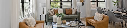 a living room with couches and chairs and a glass coffee table at The Collection Charlotte in Charlotte, NC, 28205