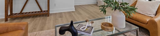 a living room with a couch and a glass coffee table at The Collection Charlotte in Charlotte, NC, 28205