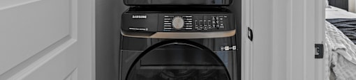 a washer and dryer stacked on top of each other in a small room at The Collection Charlotte in Charlotte, NC, 28205