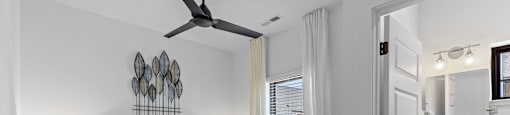 a bedroom with a bed and a ceiling fan at The Collection Charlotte in Charlotte, NC, 28205