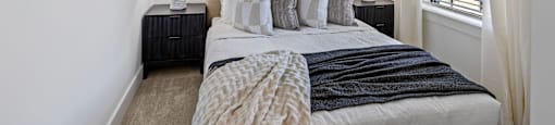 a bedroom with a large bed and a ceiling fan at The Collection Charlotte in Charlotte, NC, 28205