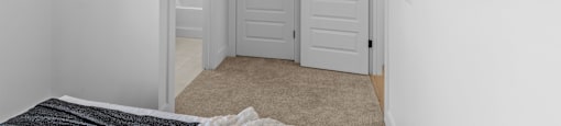 a bedroom with two closets and a bed and a door to a bathroom at The Collection Charlotte in Charlotte, NC, 28205
