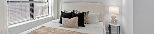 a bedroom with a large bed and a ceiling fan at The Collection Charlotte in Charlotte, NC, 28205