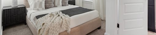 a bedroom with a bed and a ceiling fan at The Collection Charlotte in Charlotte, NC, 28205