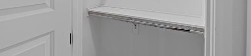 an empty closet with white walls and a white door at The Collection Charlotte in Charlotte, NC, 28205