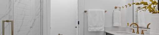 a bathroom with a shower and a sink and a mirror at The Collection Charlotte in Charlotte, NC, 28205