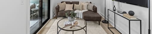 a living room with a couch and a ceiling fan at The Collection Charlotte in Charlotte, NC, 28205