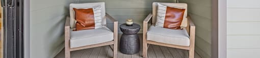 two chairs on the porch of a beach house with a tv at The Collection Charlotte in Charlotte, NC, 28205