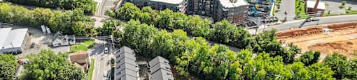 an aerial view of a city with buildings and trees at The Collection Charlotte in Charlotte, NC, 28205