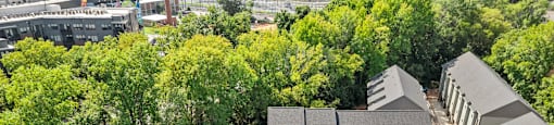 an aerial view of a building surrounded by trees at The Collection Charlotte in Charlotte, NC, 28205