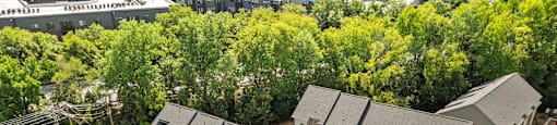 an aerial view of a building surrounded by trees at The Collection Charlotte in Charlotte, NC, 28205