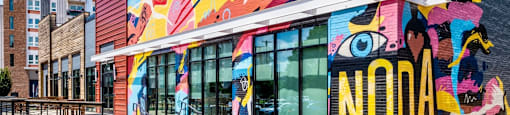 a colorful mural on the side of a building at The Collection Charlotte in Charlotte, NC, 28205