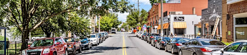 a city street with cars parked on the side of the road at The Collection Charlotte in Charlotte, NC, 28205