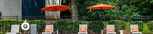 a swimming pool with chairs and umbrellas next to a resort pool at Glen Hollow, Georgia 30034