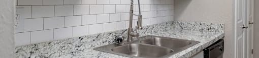 a kitchen with a sink and white cabinetsat Glen Hollow,Decatur, GA, 30034