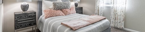 a bedroom with a bed and two nightstands and a window at Tucker Square, Stone Mountain 30083