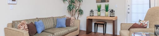 a living room with a couch and a chair and a table