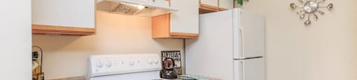 a kitchen with a white stove and a refrigerator