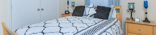 a bedroom with a bed and a dresser and a window