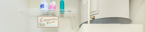 a white laundry room with two washes and a dryer at The Villages at Lost Creek, San Antonio, 78247