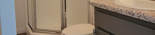 a bathroom with a toilet and a shower and a sink at Villa La Paz Apartments, California, 90706