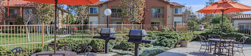 an outdoor patio with tables and chairs and umbrellas at Riverview Springs, Oceanside