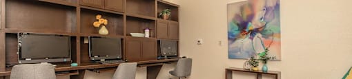 A room with a desk, chairs, and a painting on the wall at The Villages at Lost Creek Apartments, San Antonio, 78247