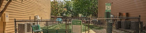 A fenced area with a sign at The Villages at Lost Creek Apartments, San Antonio