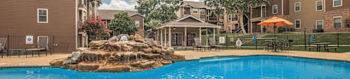 A large swimming pool in front of apartment buildings at The Villages at Lost Creek Apartments, San Antonio, Texas