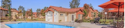 a pool with chairs and umbrellas next to a pool at Riverview Springs, Oceanside, CA