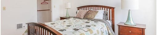 a bedroom with a bed and two night stands at Riverview Springs, Oceanside