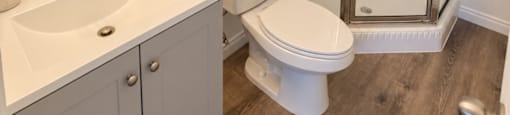 A white sink and toilet in a bathroom with a glass shower door.