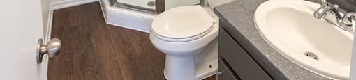 A white toilet sits in a bathroom next to a sink and a shower.